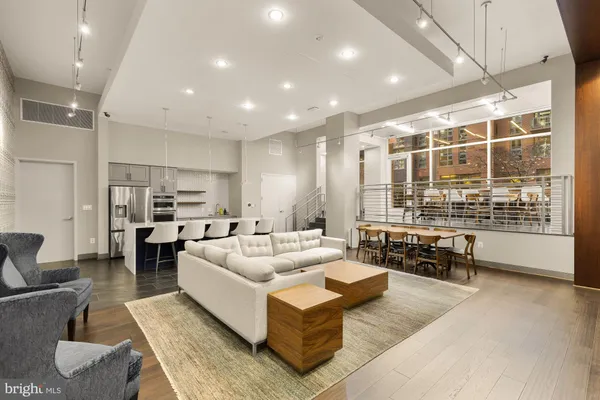 a living room with fireplace furniture and a large window