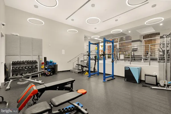 a room with gym equipment and a view of living room