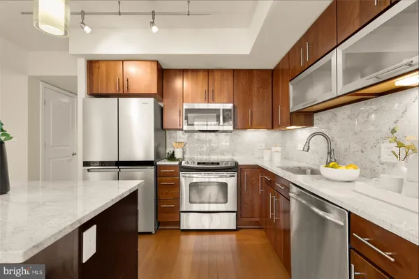 a kitchen with stainless steel appliances a sink a stove and a refrigerator