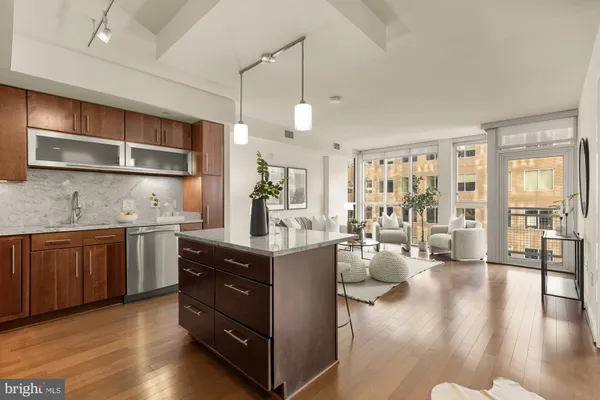 a kitchen with a stove cabinets and wooden floor