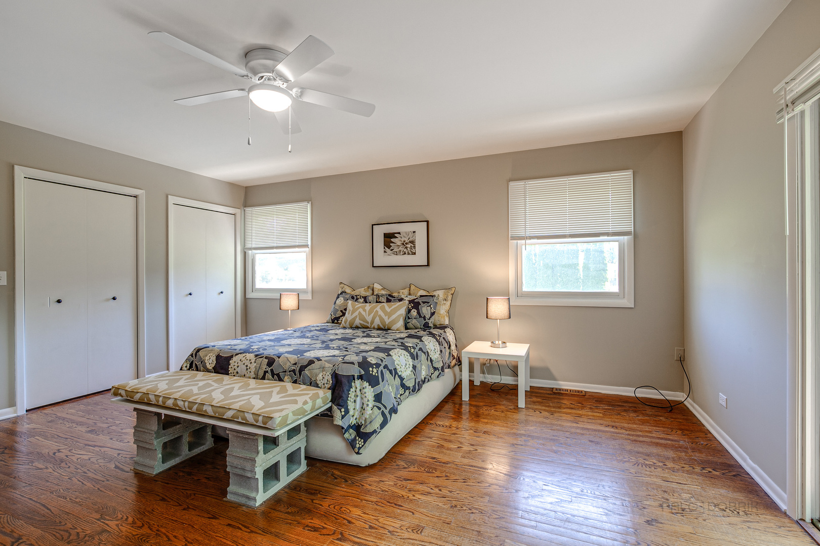 235 Waverly Road Barrington, IL 60010 - Photo 19 of 26 a bedroom with a bed and a table with wooden floor