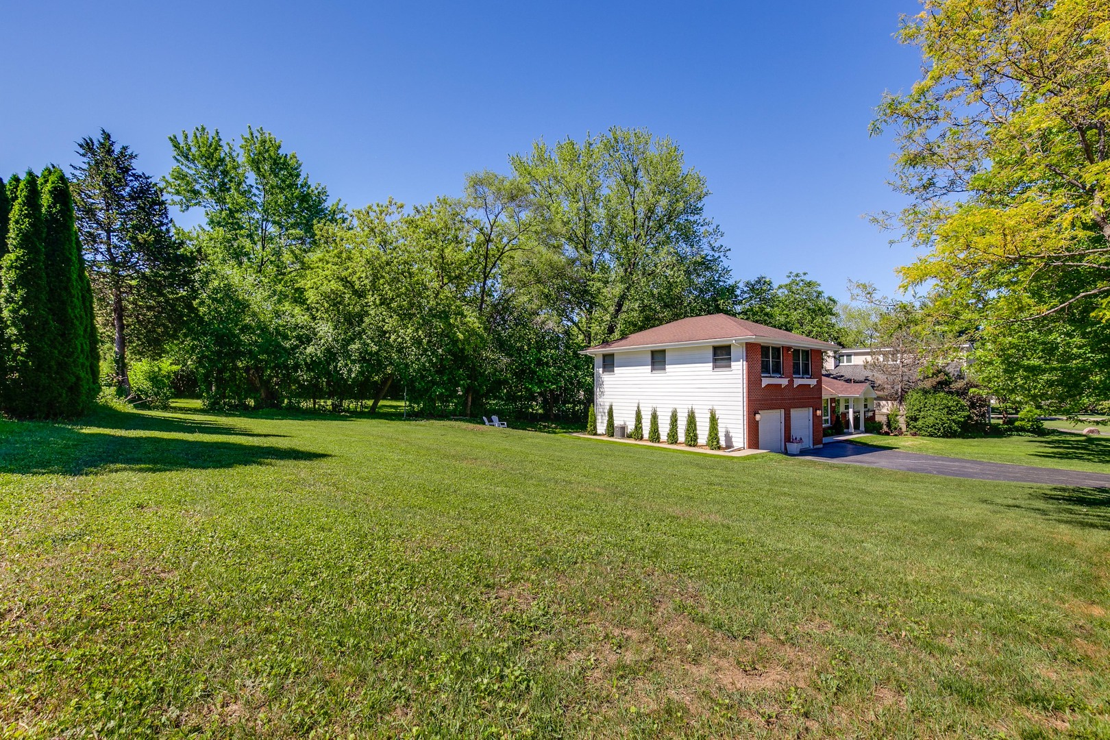 235 Waverly Road Barrington, IL 60010 - Photo 23 of 26 a big house with a big yard and large trees