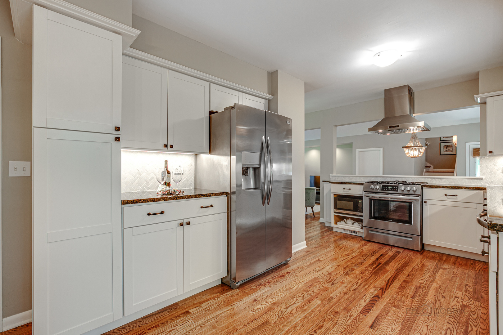235 Waverly Road Barrington, IL 60010 - Photo 10 of 26 a kitchen with cabinets wooden floor and stainless steel appliances