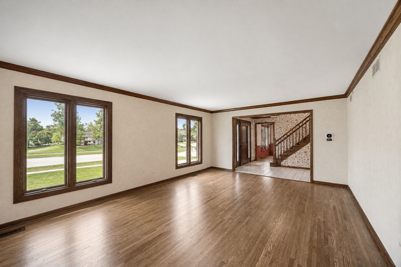 6723 Kingswood Road Willowbrook, IL 60527 - Photo 10 of 51 a view of an empty room with wooden floor and a window