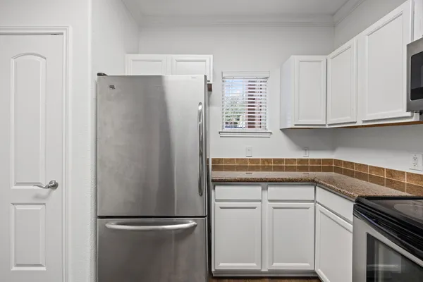 a kitchen with appliances cabinets and a counter top space
