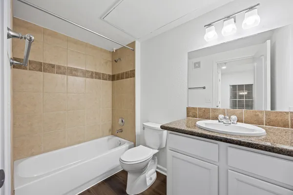 a bathroom with a sink a toilet and bathtub