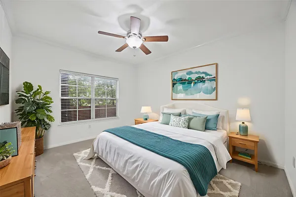 a bedroom with a bed and a potted plant