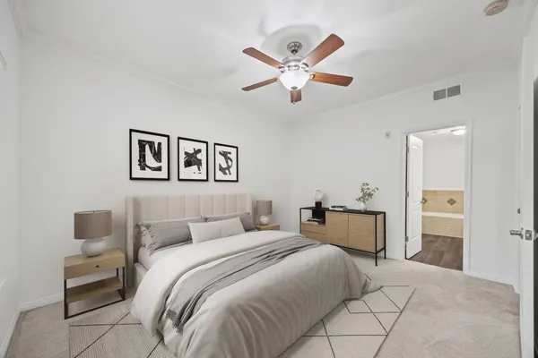a bedroom with a bed and a chandelier