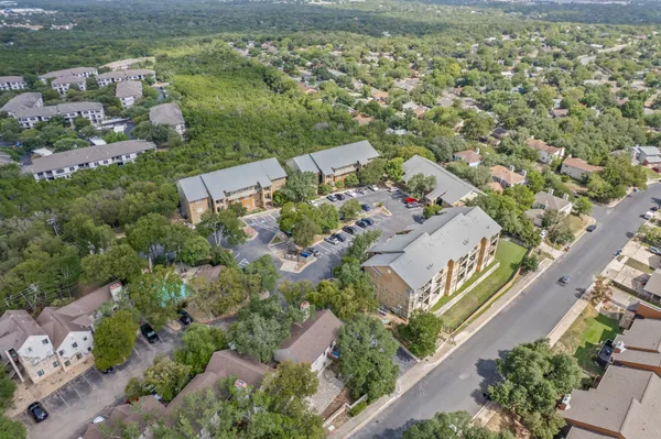 an aerial view of a house with a yard