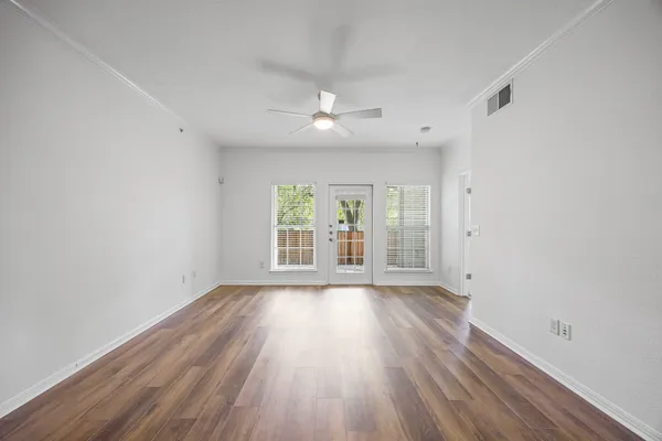 wooden floor in an empty room with a window