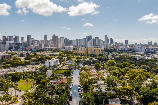a living room with furniture and painting on the wall