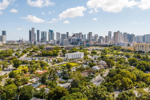 a view of a chair and table in backyard of the house