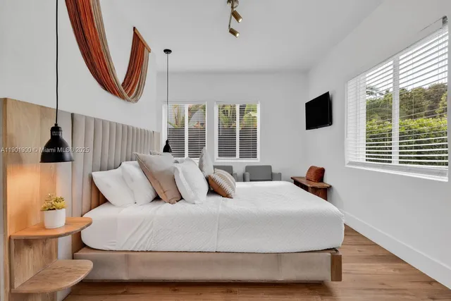 a bedroom with a large bed and a window