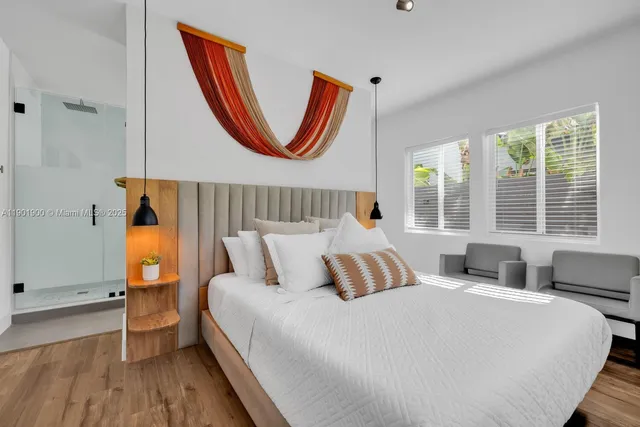 a bedroom with a bed and a flat screen tv