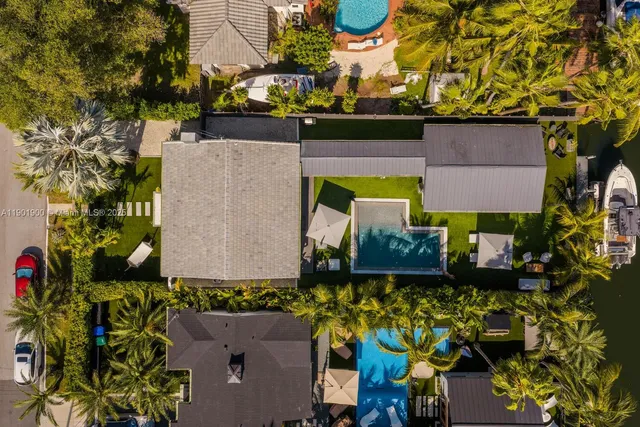 an aerial view of a house with a yard and lake view
