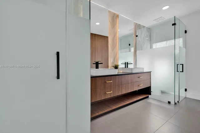 a bathroom with a double vanity sink and mirror