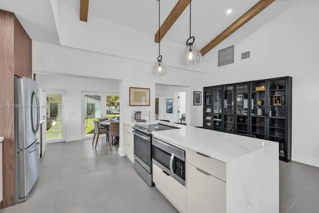 a backyard of a house with table and chairs