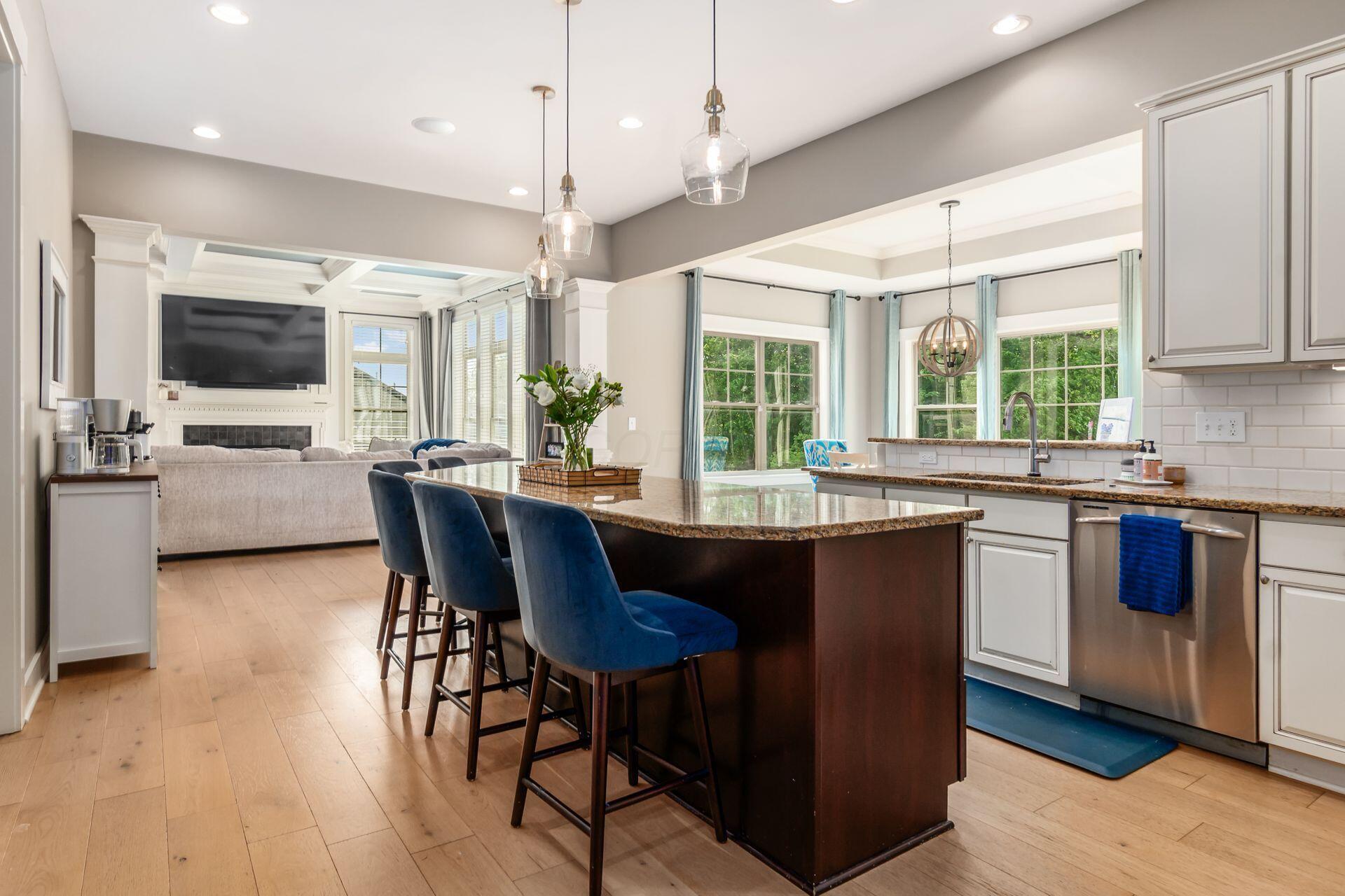 1002 Rambling Brook Way Delaware, OH 43015 - Photo 21 of 104 Spacious kitchen with center island, stainless steel appliances including gas range and double oven, built in microwave, beverage refrigerator, walk-in pantry and sunny breakfast room.