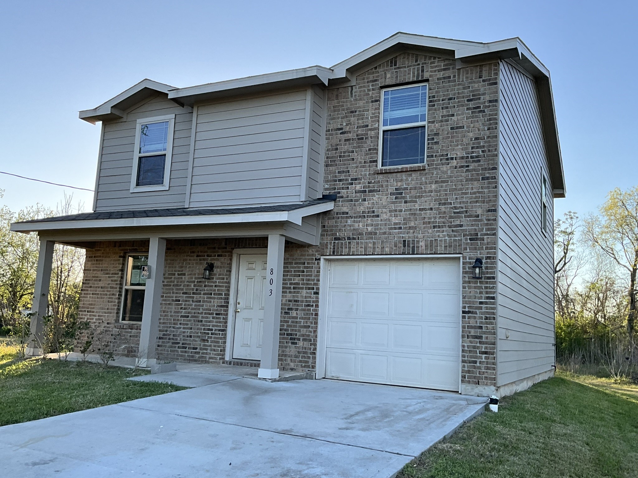 803 North Spanish Camp Road Wharton, TX 77488 - Photo 1 of 13 a front view of a house with a garden