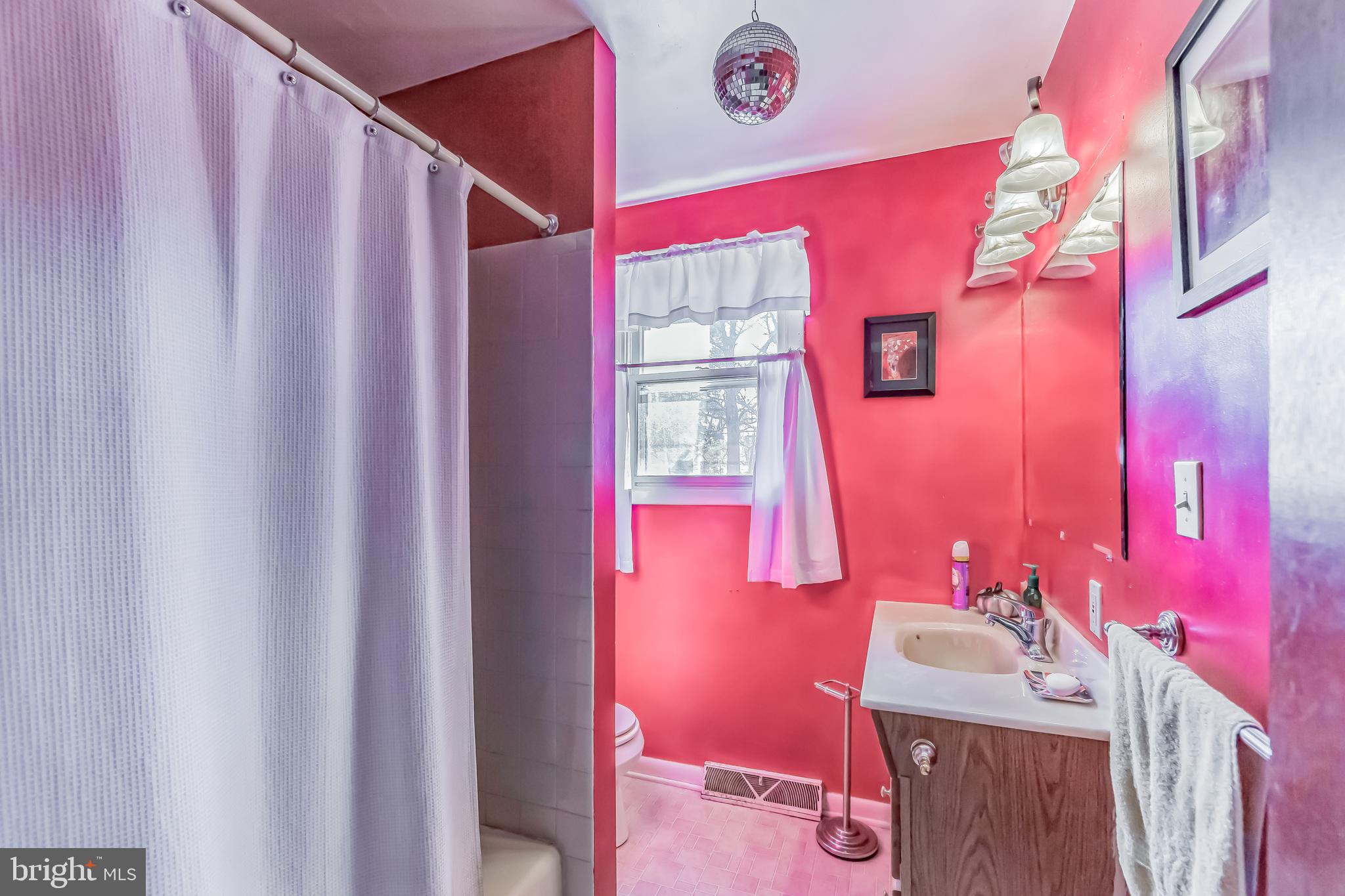 300 Cornell Road Glassboro, NJ 08028 - Photo 33 of 49 a bathroom with a sink a mirror and a shower curtain