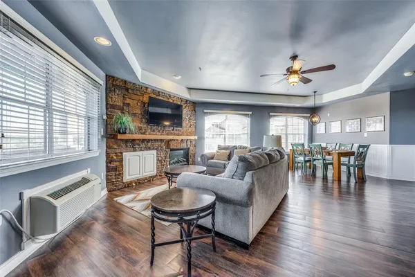 a living room with fireplace furniture and a flat screen tv