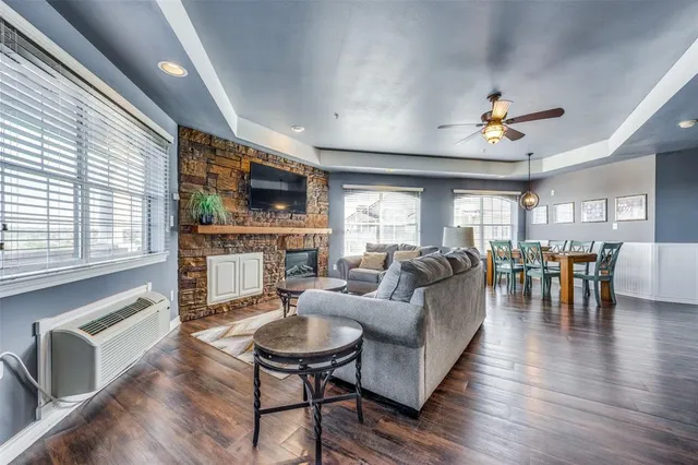 a living room with fireplace furniture and a flat screen tv