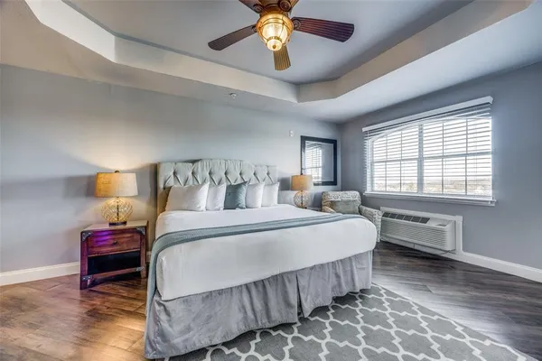 a bedroom with bed and a chandelier