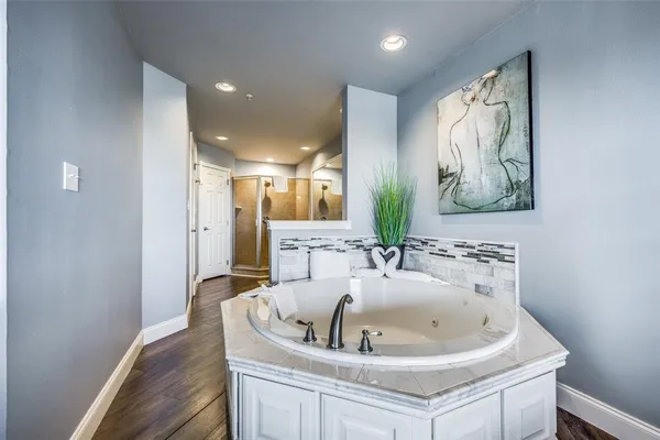 a bathroom with a bathtub and a sink