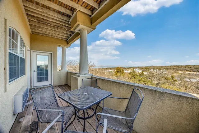 a view of a balcony with table and chairs