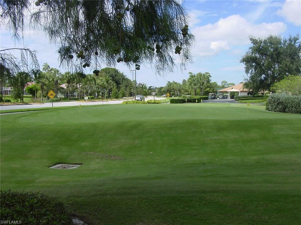 6740 Dennis Circle, Unit B103 Naples, FL 34104 - Photo 14 of 16 a view of field with tall trees