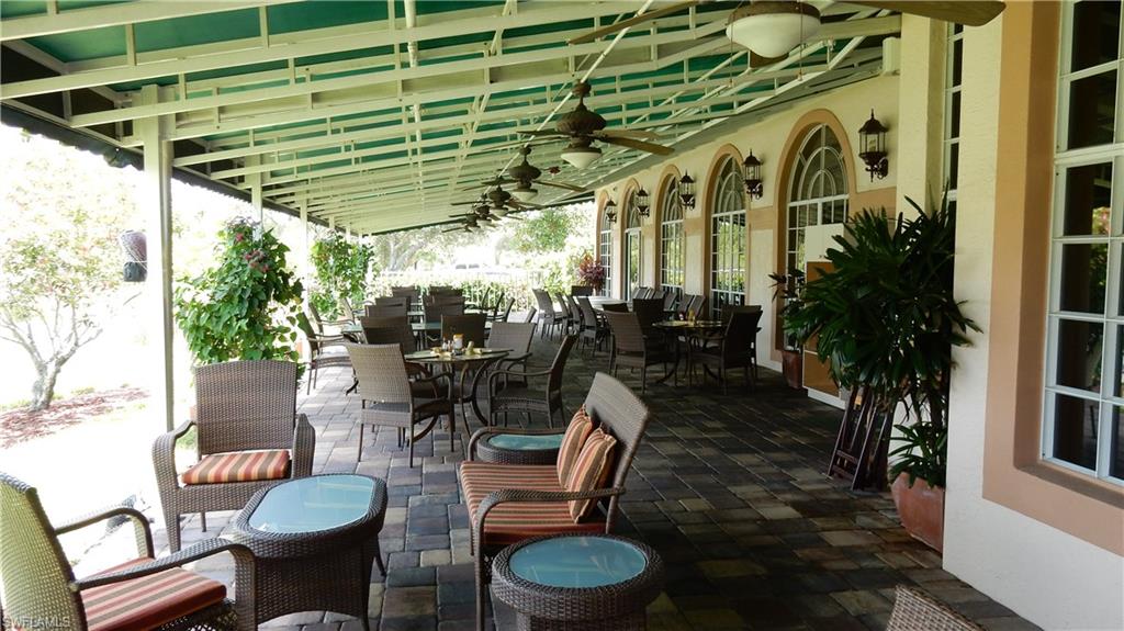 6740 Dennis Circle, Unit B103 Naples, FL 34104 - Photo 15 of 16 a view of a patio with chairs and potted plants
