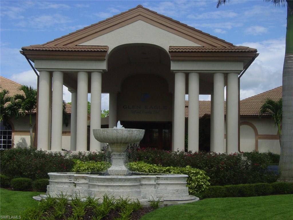 6740 Dennis Circle, Unit B103 Naples, FL 34104 - Photo 16 of 16 a front view of a house with garden