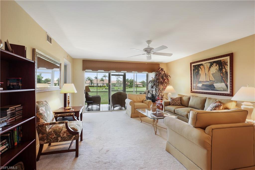 6740 Dennis Circle, Unit B103 Naples, FL 34104 - Photo 2 of 16 a living room with furniture and a flat screen tv