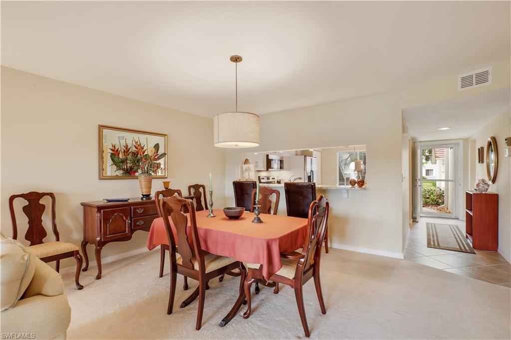 6740 Dennis Circle, Unit B103 Naples, FL 34104 - Photo 4 of 16 a view of a dining room with furniture