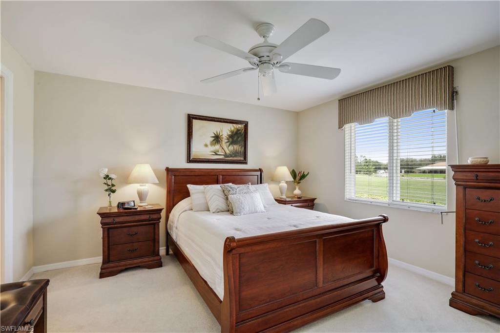6740 Dennis Circle, Unit B103 Naples, FL 34104 - Photo 6 of 16 a bedroom with a bed and a window
