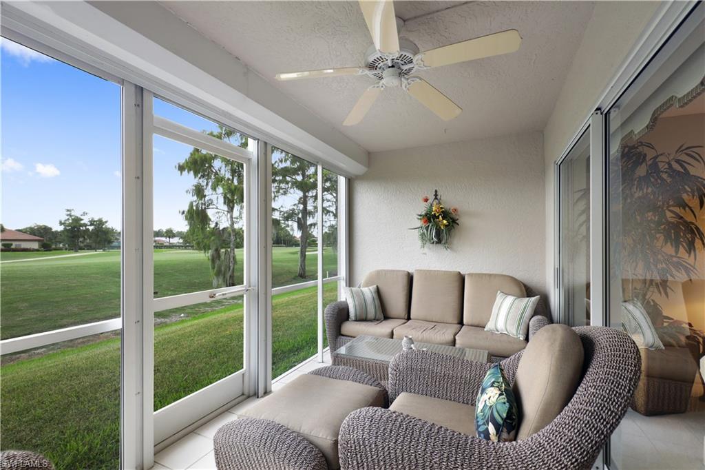 6740 Dennis Circle, Unit B103 Naples, FL 34104 - Photo 10 of 16 a living room with furniture and a yard
