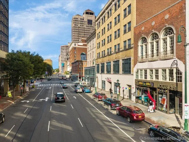 a city street lined with buildings and cars