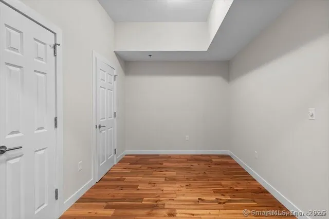 a view of a room with wooden floor