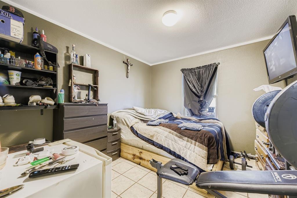 2228 Sims Drive Fort Worth, TX 76119 - Photo 12 of 15 a bedroom with a bed and furniture