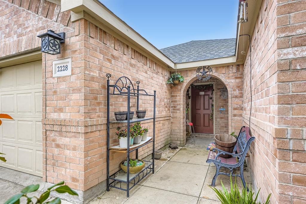 2228 Sims Drive Fort Worth, TX 76119 - Photo 2 of 15 a front view of a building with outdoor seating