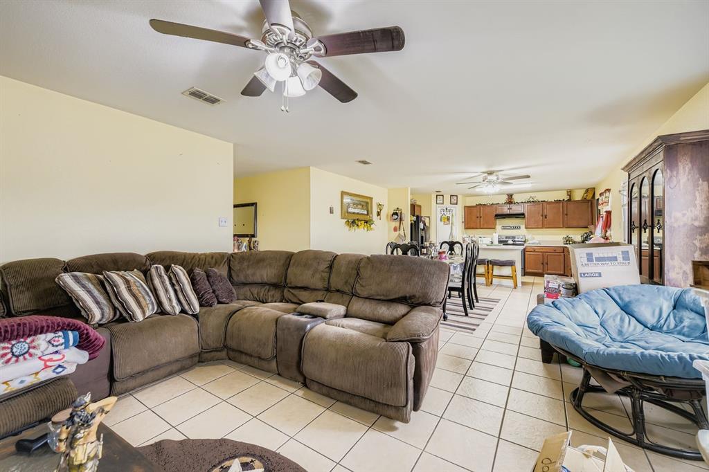 2228 Sims Drive Fort Worth, TX 76119 - Photo 6 of 15 a living room with furniture and a chandelier