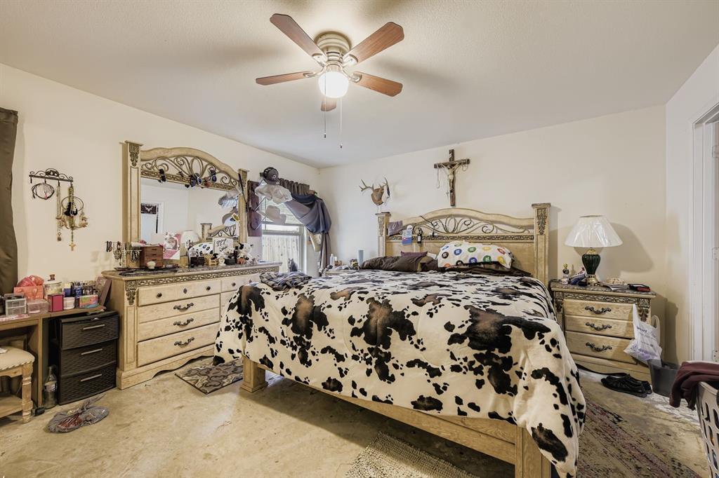 2228 Sims Drive Fort Worth, TX 76119 - Photo 8 of 15 a bedroom with a bed and a chandelier