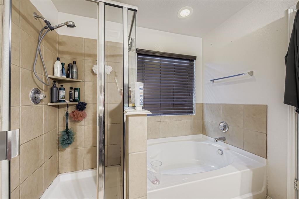 2228 Sims Drive Fort Worth, TX 76119 - Photo 9 of 15 a bathroom with a bathtub and a shower
