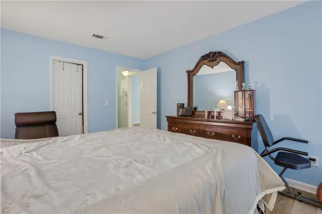 a bedroom with a bed and a mirror