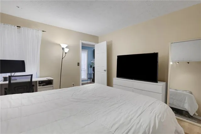 a bedroom with a bed and a flat screen tv