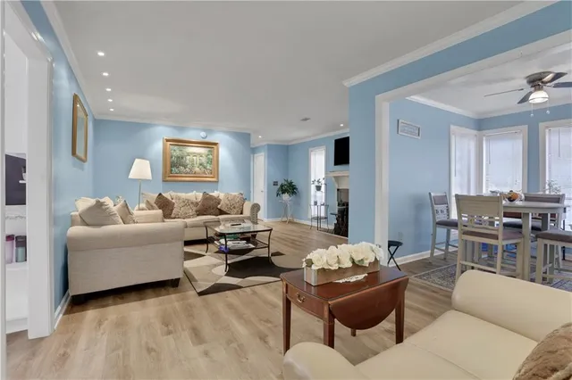 a living room with furniture and view of kitchen