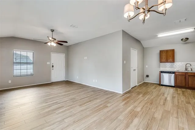 a view of a kitchen with wooden floor and a ceiling fan
