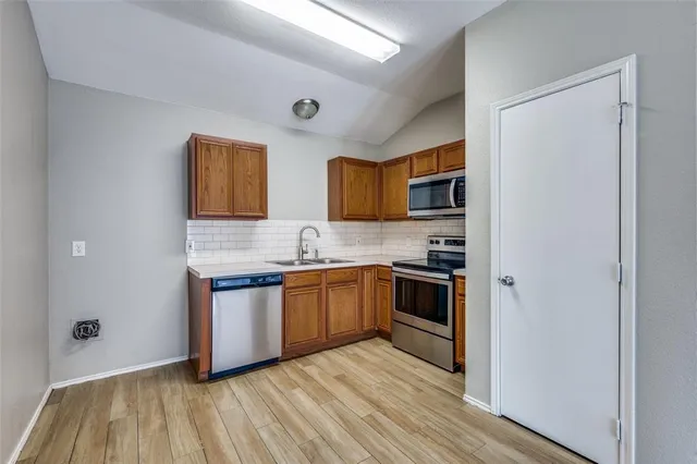 a kitchen with stainless steel appliances granite countertop a stove and a refrigerator