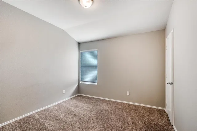 an empty room with a empty space and window