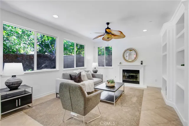 a living room with furniture a clock and a fireplace